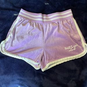 Purple shorts with “self love”.